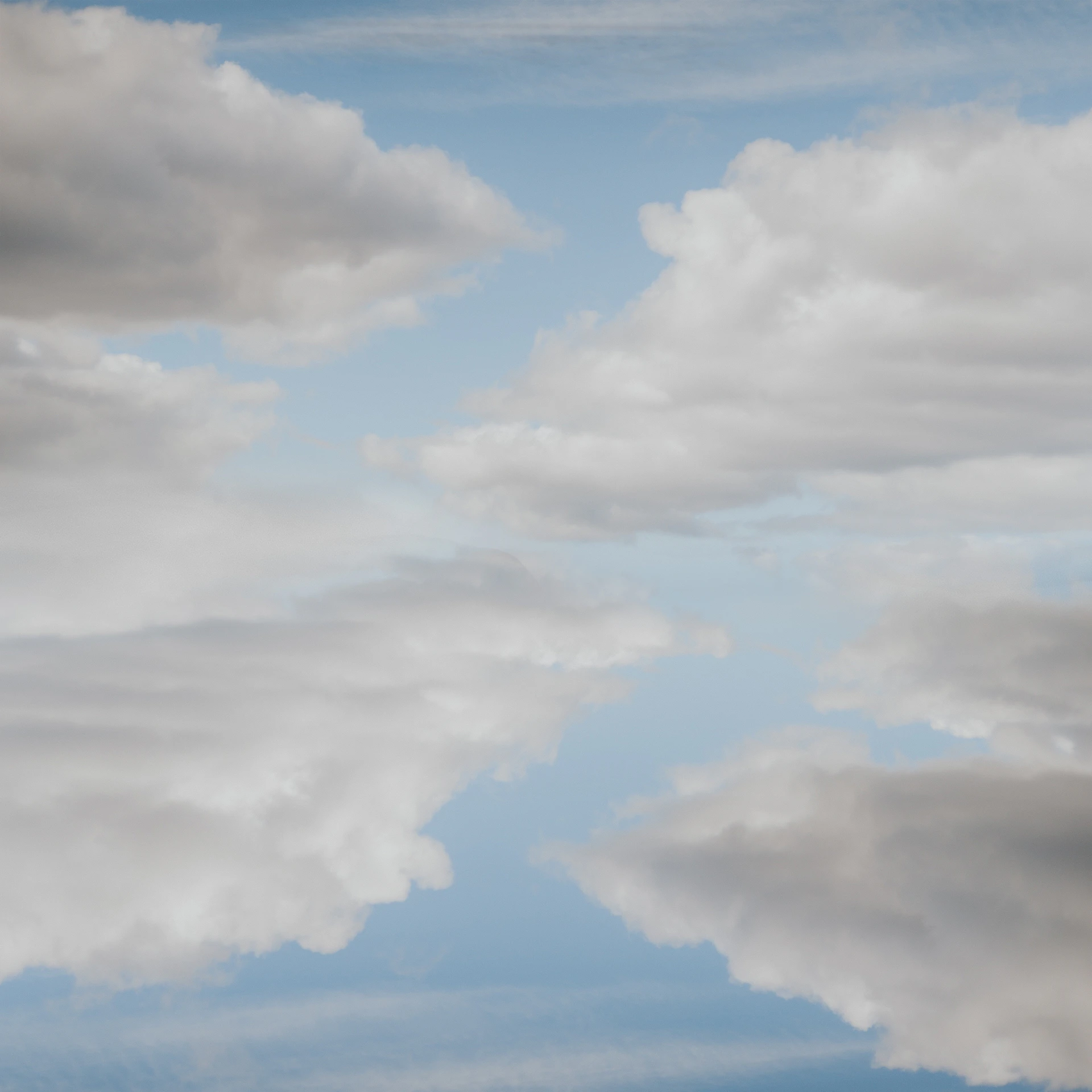 a plane flying through a cloudy blue sky