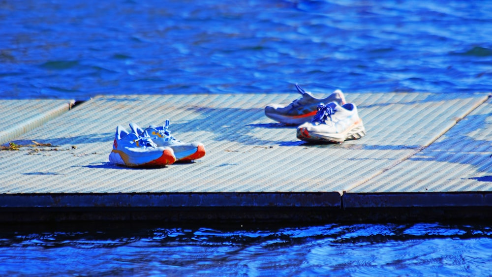 three pairs of shoes are sitting on a dock
