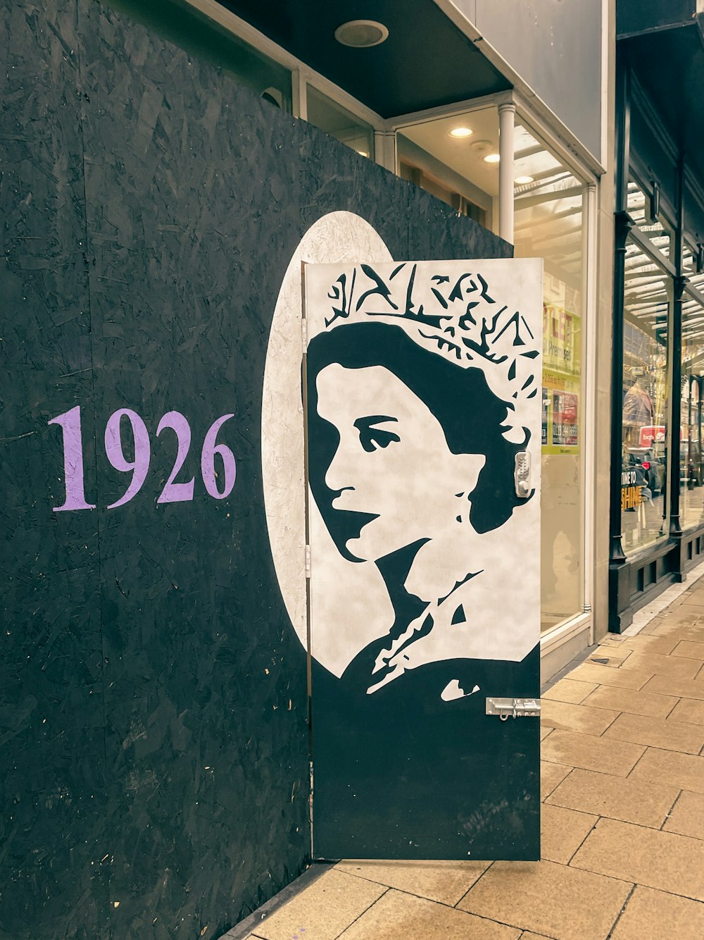 a black and white picture of a woman on the side of a building