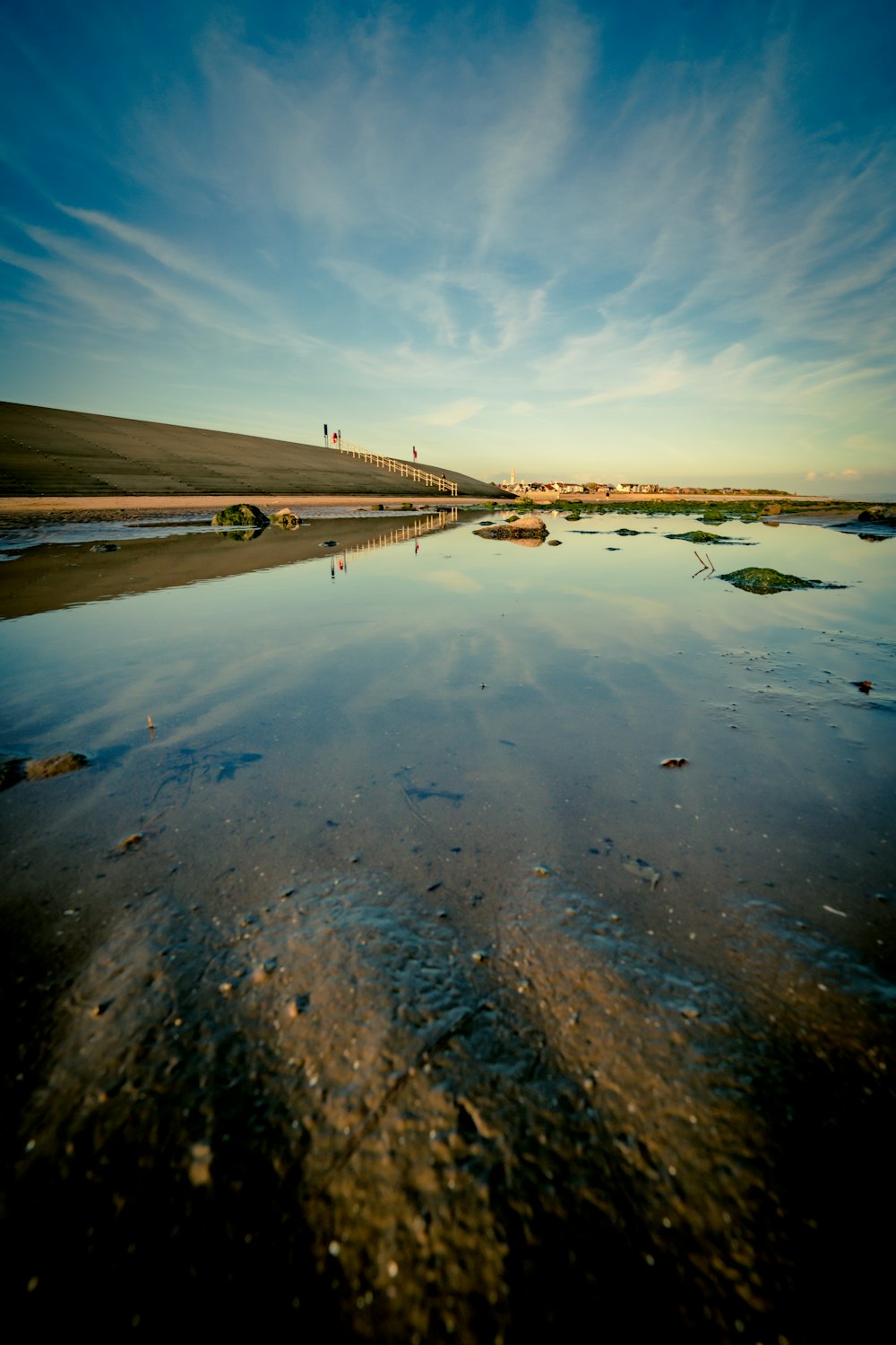 a body of water with a bridge in the background