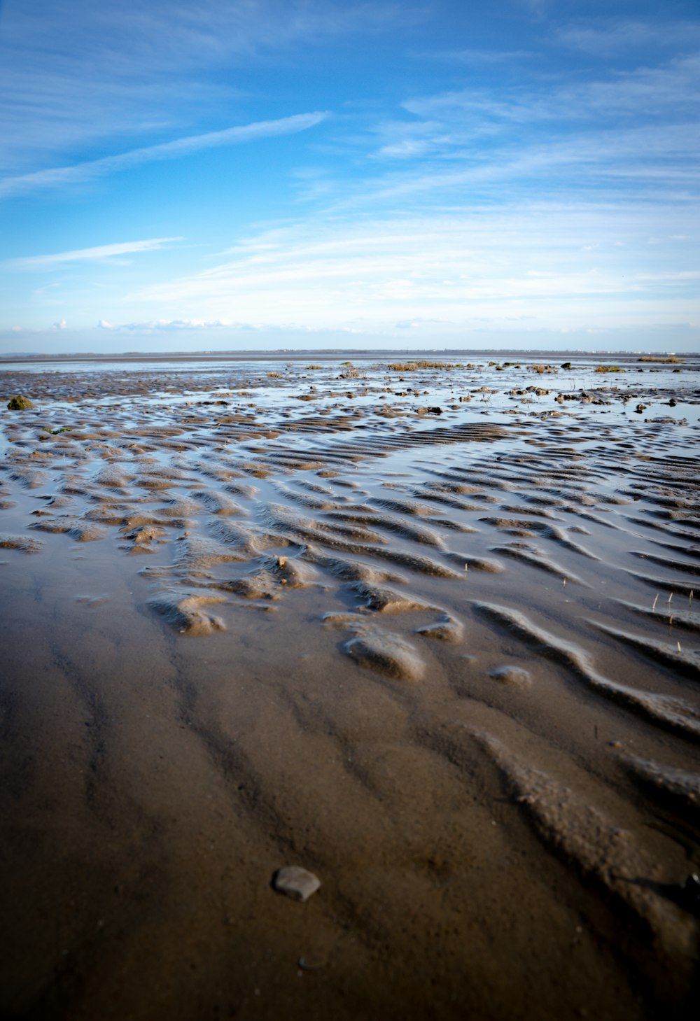 a sandy beach with footprints in the sand