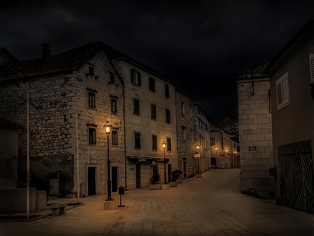 an empty street at night with lights on