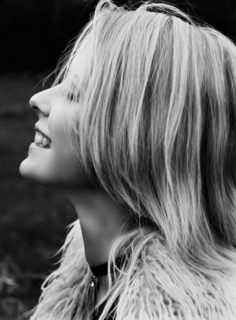 An inspiring image of a person with full, healthy hair enjoying life.