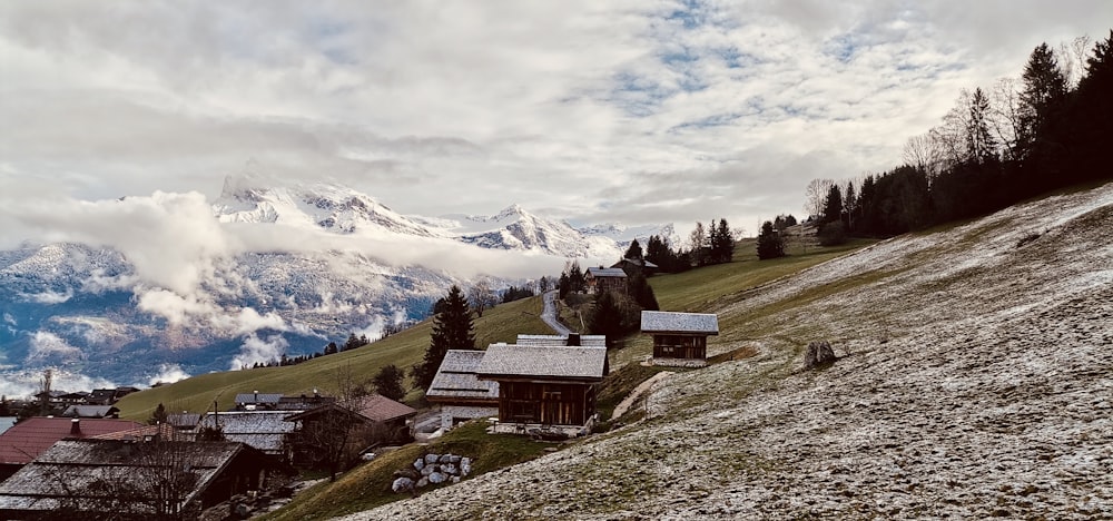 a snow covered mountain with houses on the side of it