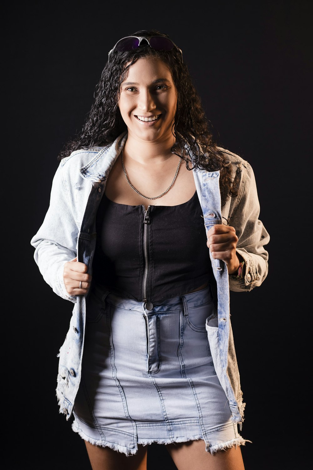 a woman in a skirt and jacket posing for a picture