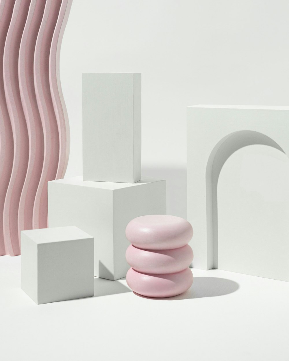a group of white and pink objects on a white surface