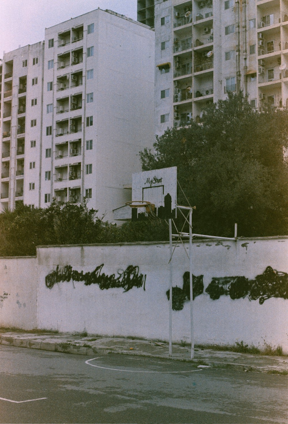 a basketball court in front of a tall building