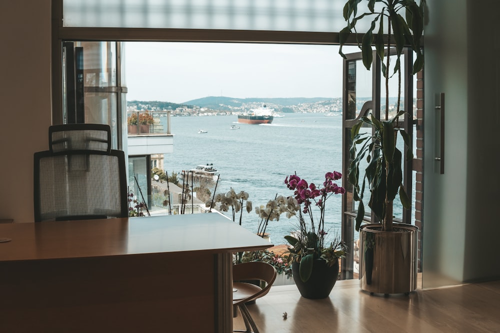 a living room with a large window overlooking the water