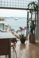 Spacious living room with floor-to-ceiling windows overlooking the water.