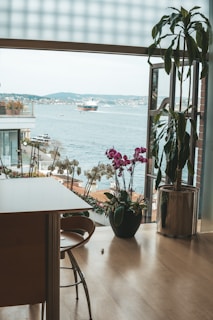 Spacious living room with floor-to-ceiling windows overlooking the water.
