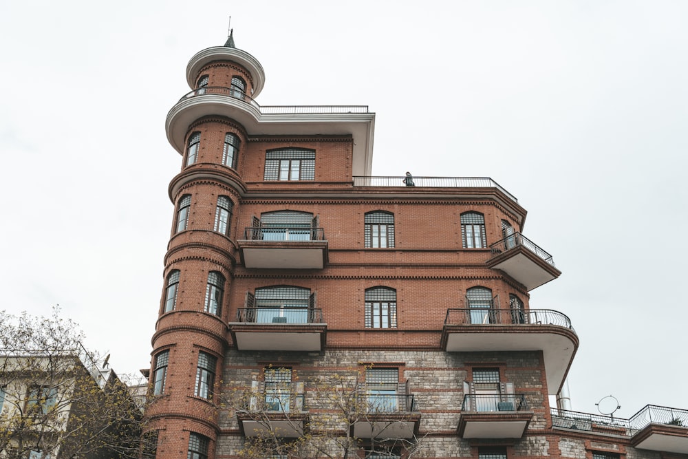 a tall brick building with a clock on the front of it