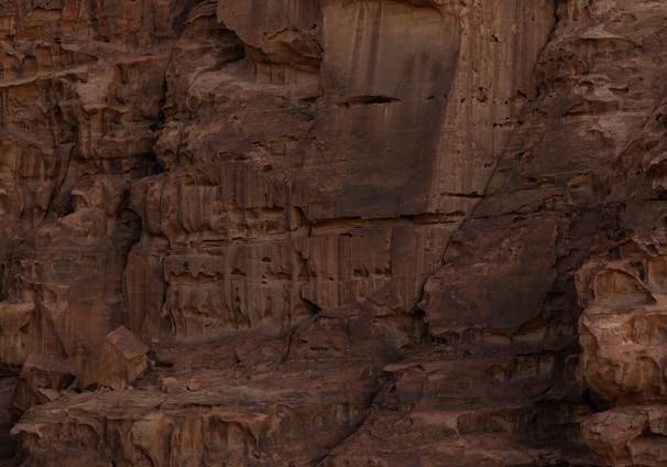 a person standing on a rock ledge in the desert