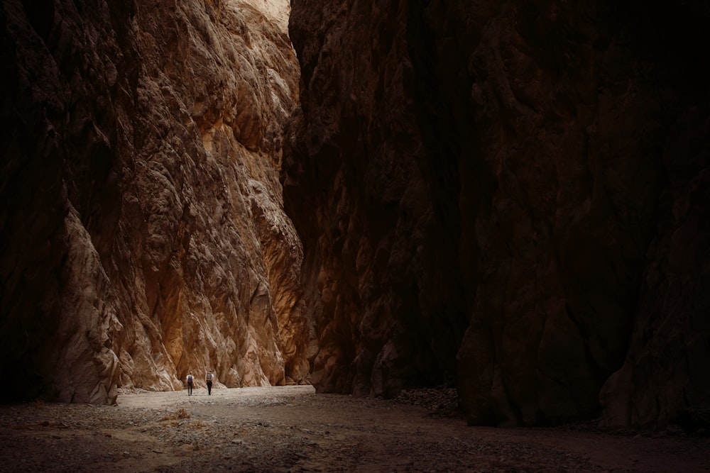 Un uomo in piedi in uno stretto canyon tra due montagne