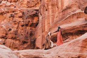 a couple of people that are standing in the dirt