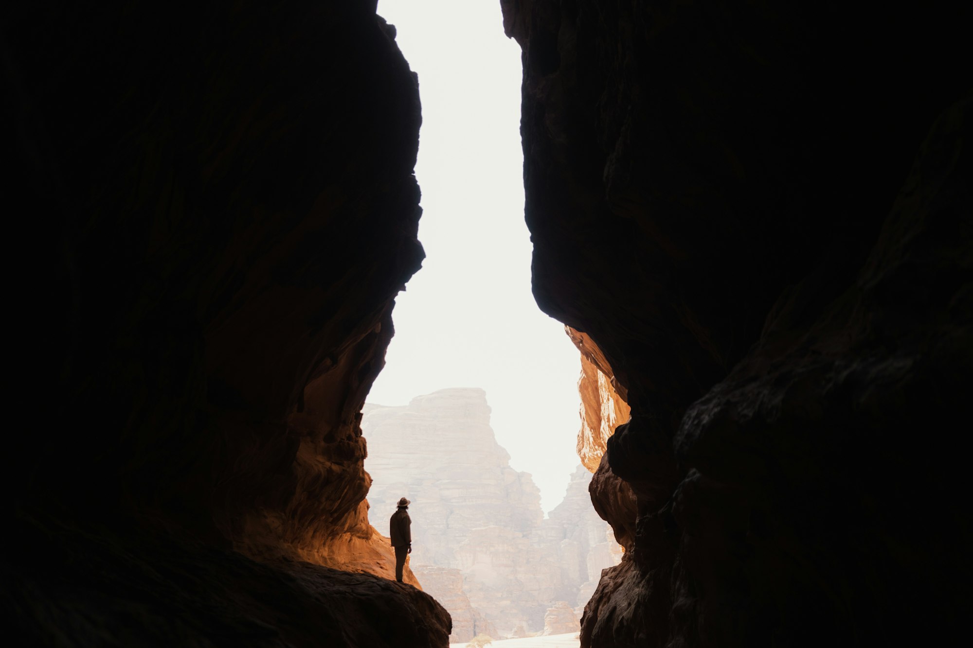 a person standing in the middle of a cave