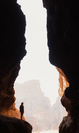 a person standing in the middle of a cave