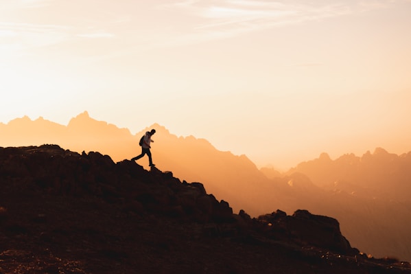 a person standing on top of a mountain, walking
