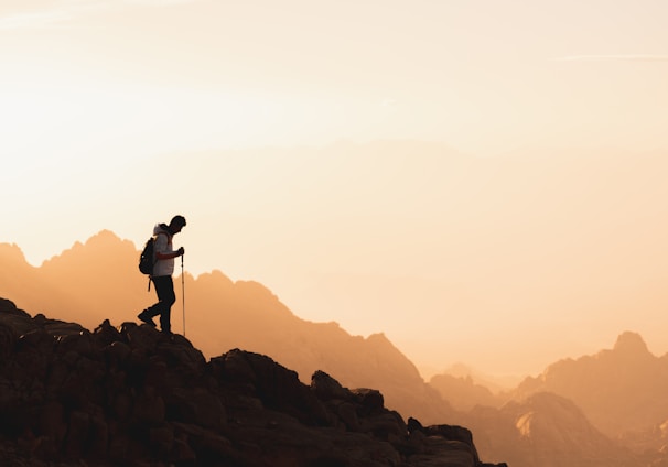 a couple of people standing on top of a mountain