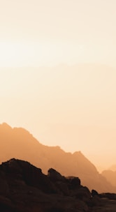 a couple of people standing on top of a mountain