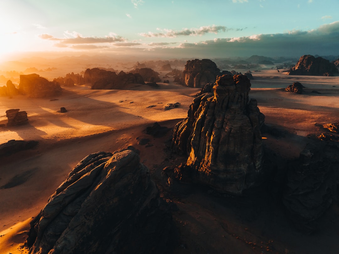 an aerial view of a desert at sunset