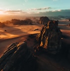 an aerial view of a desert at sunset