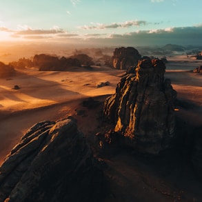 an aerial view of a desert at sunset