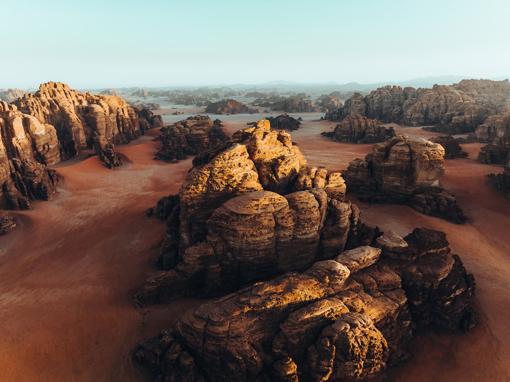 an aerial view of a desert with rocks and sand