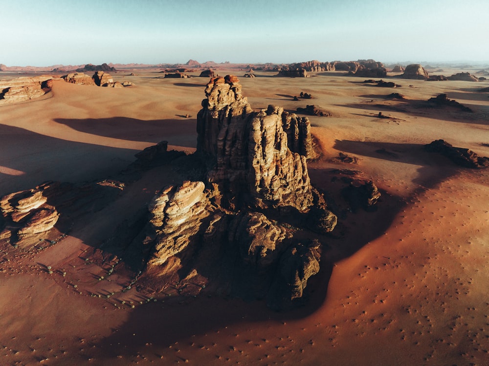 an aerial view of a desert with rocks and sand