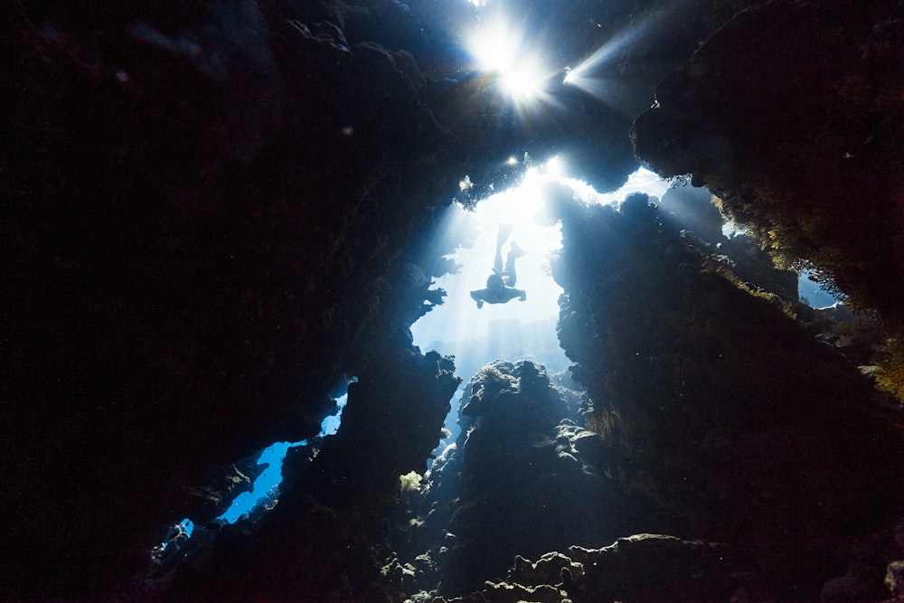the sun shines through the water in a cave