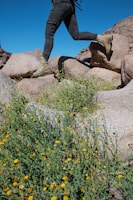 a man with a backpack is running on rocks