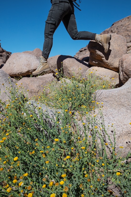a man with a backpack is running on rocks