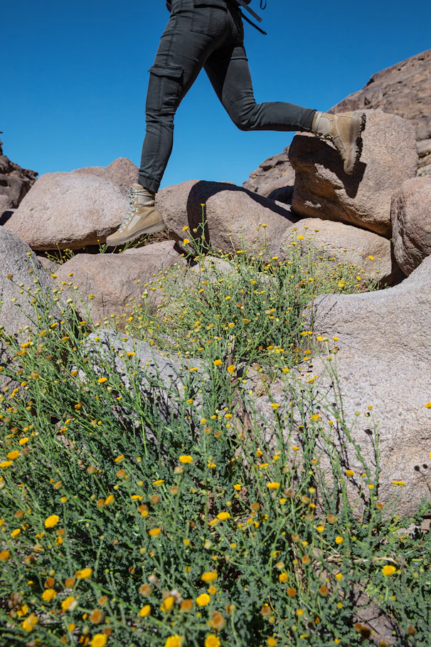 a man with a backpack is running on rocks