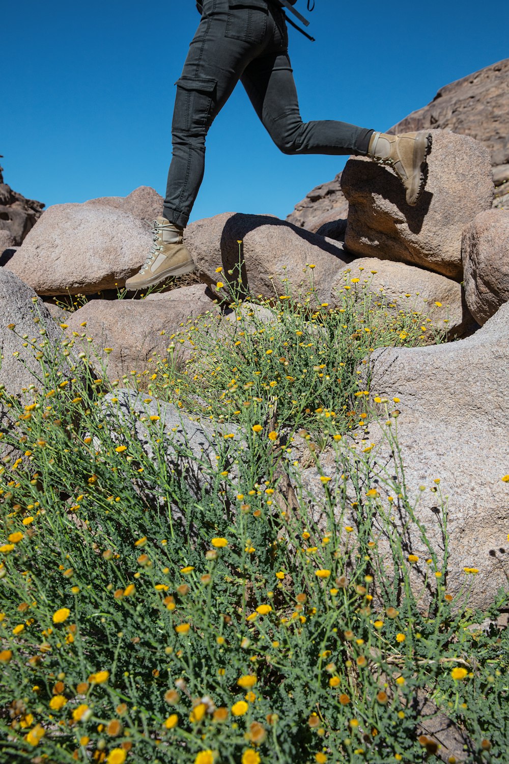 a man with a backpack is running on rocks