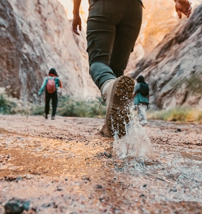 a couple of people that are walking in the dirt