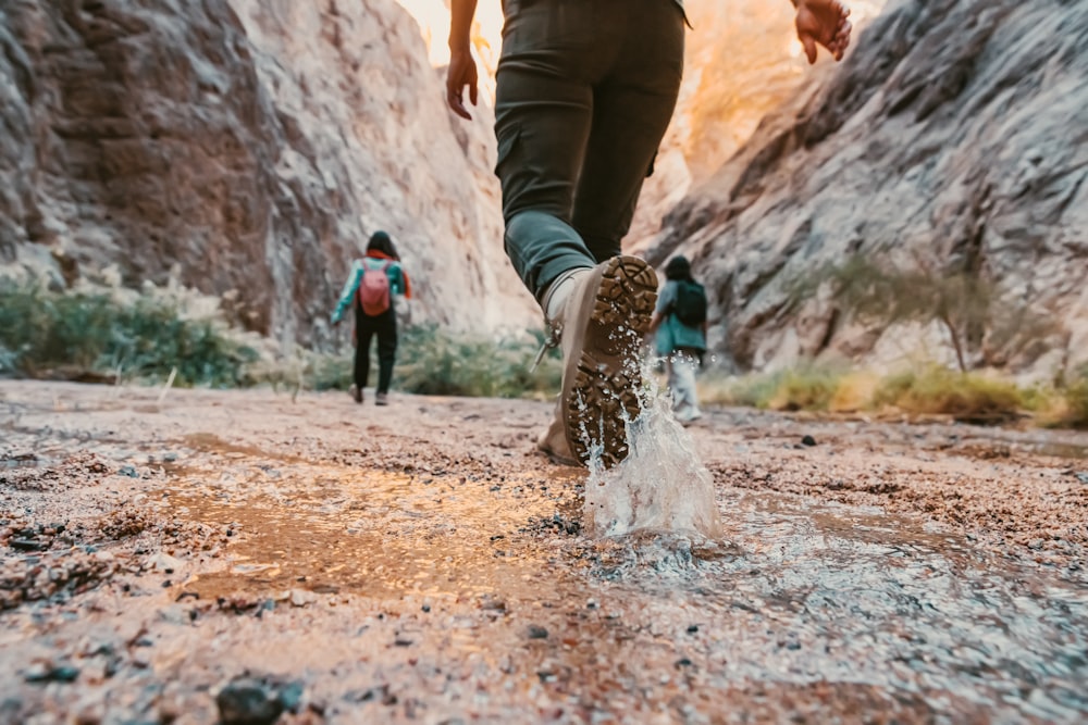 a couple of people that are walking in the dirt