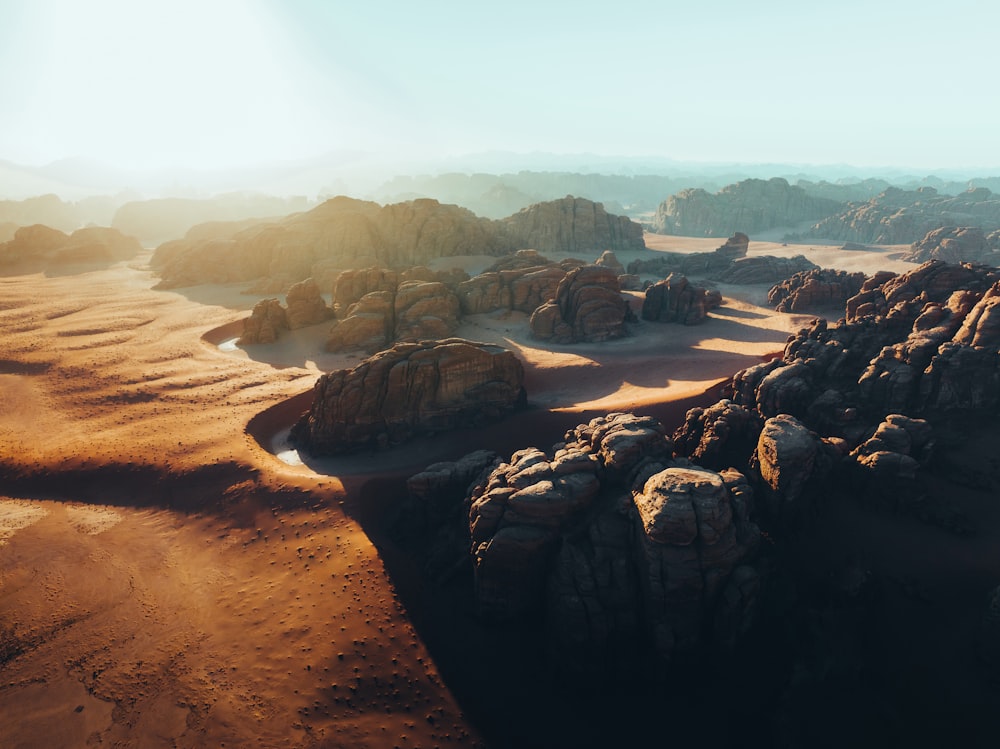 an aerial view of a desert with rocks and sand