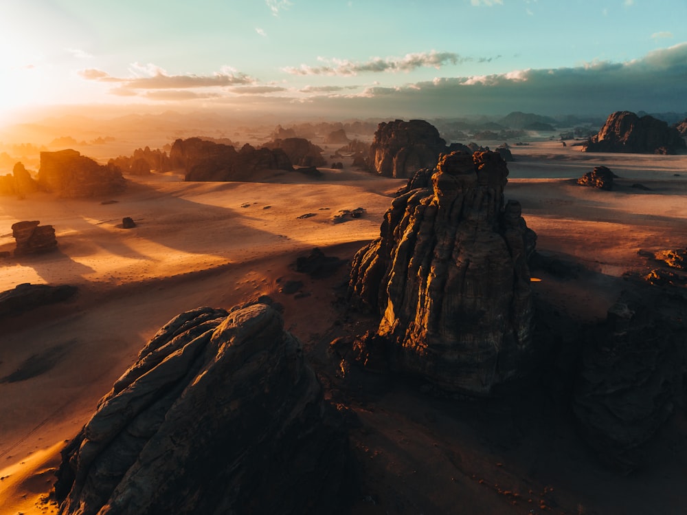 an aerial view of a desert with rocks and sand