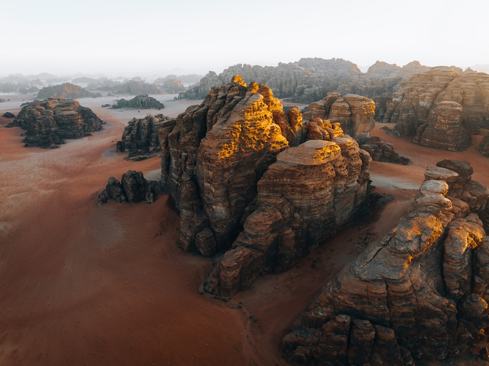 an aerial view of a desert with rocks and sand