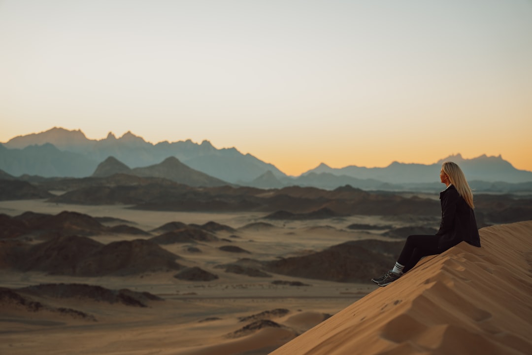 Blonde woman sitting alone in Saudi Arabian desert landscape -  Customer Lifetime Value –  Photo by NEOM | best digital marketing - London, Bristol and Bath marketing agency