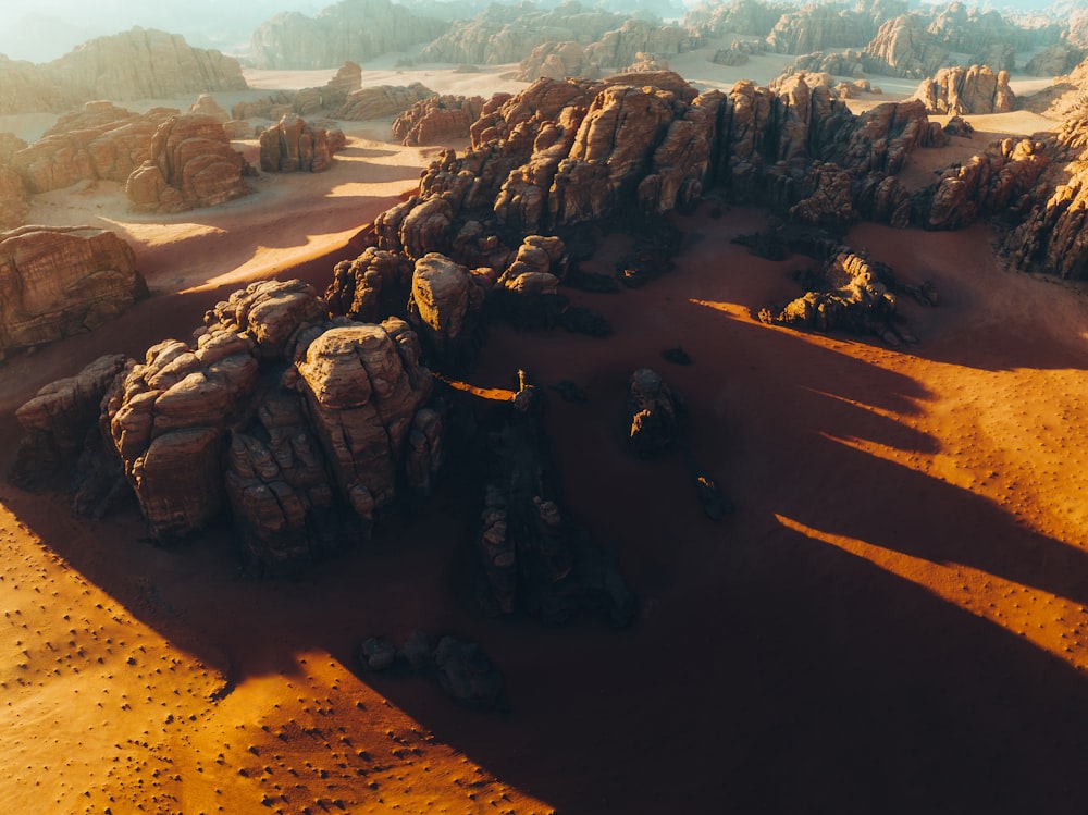 an aerial view of a desert with rocks and sand