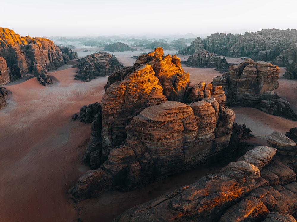 an aerial view of a desert with rocks and sand