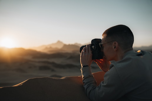 a man taking a picture of an animal with a camera
