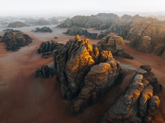 an aerial view of a desert with rocks and sand