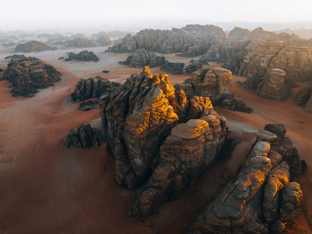 an aerial view of a desert with rocks and sand