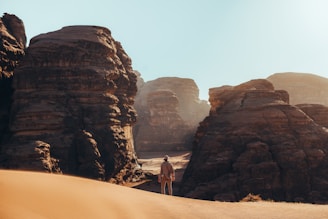 a man standing in the middle of a desert