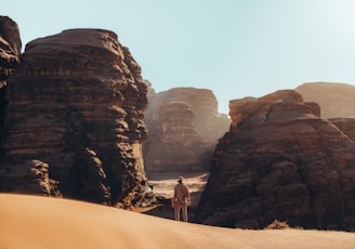 a man standing in the middle of a desert