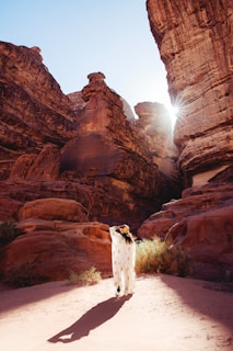 a woman standing in the middle of a desert