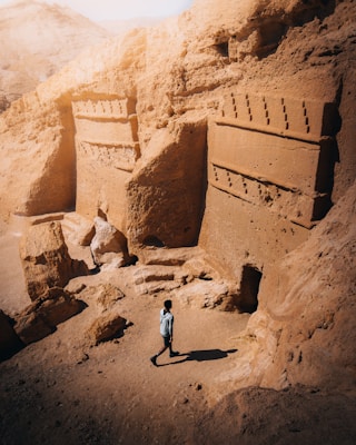 a man standing in front of some rocks