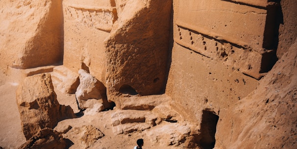 a man standing in front of some rocks