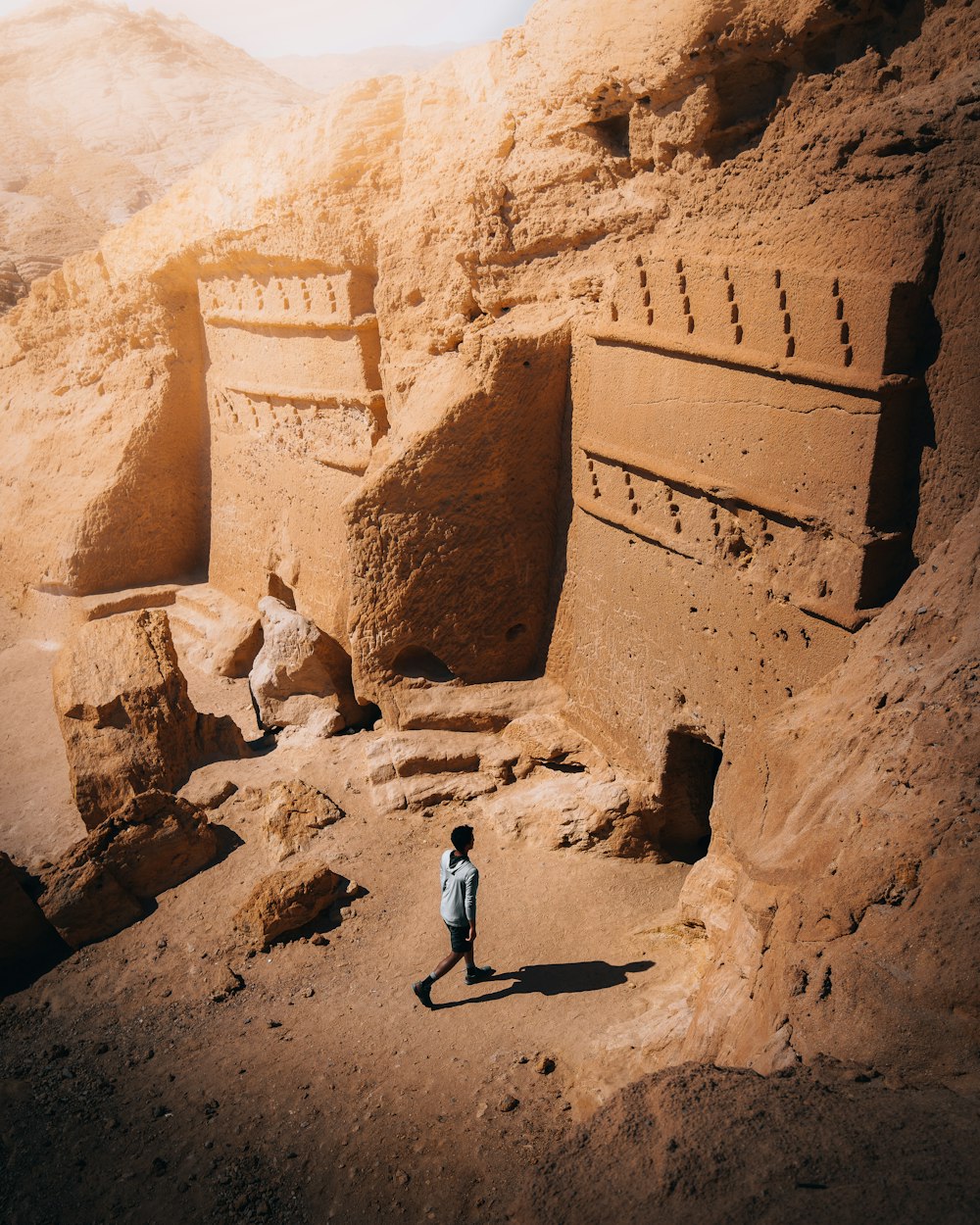 a man standing in front of some rocks